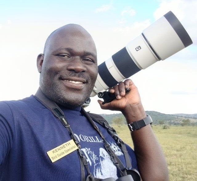 Kenneth Tumusiime, founder of Save Shoebill Conservation Project, with a camera in the field